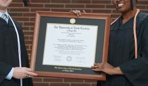 A Diploma In A Diploma Frame Being Shown Off For Photo